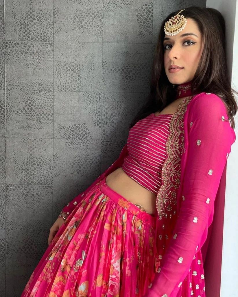 Vibrant pink floral-printed georgette lehenga choli paired with a matching sheer embroidered jacket