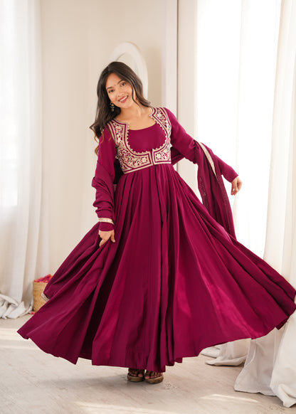 Rani pink Roman silk Anarkali gown featuring a flared silhouette and an intricately embroidered short jacket
