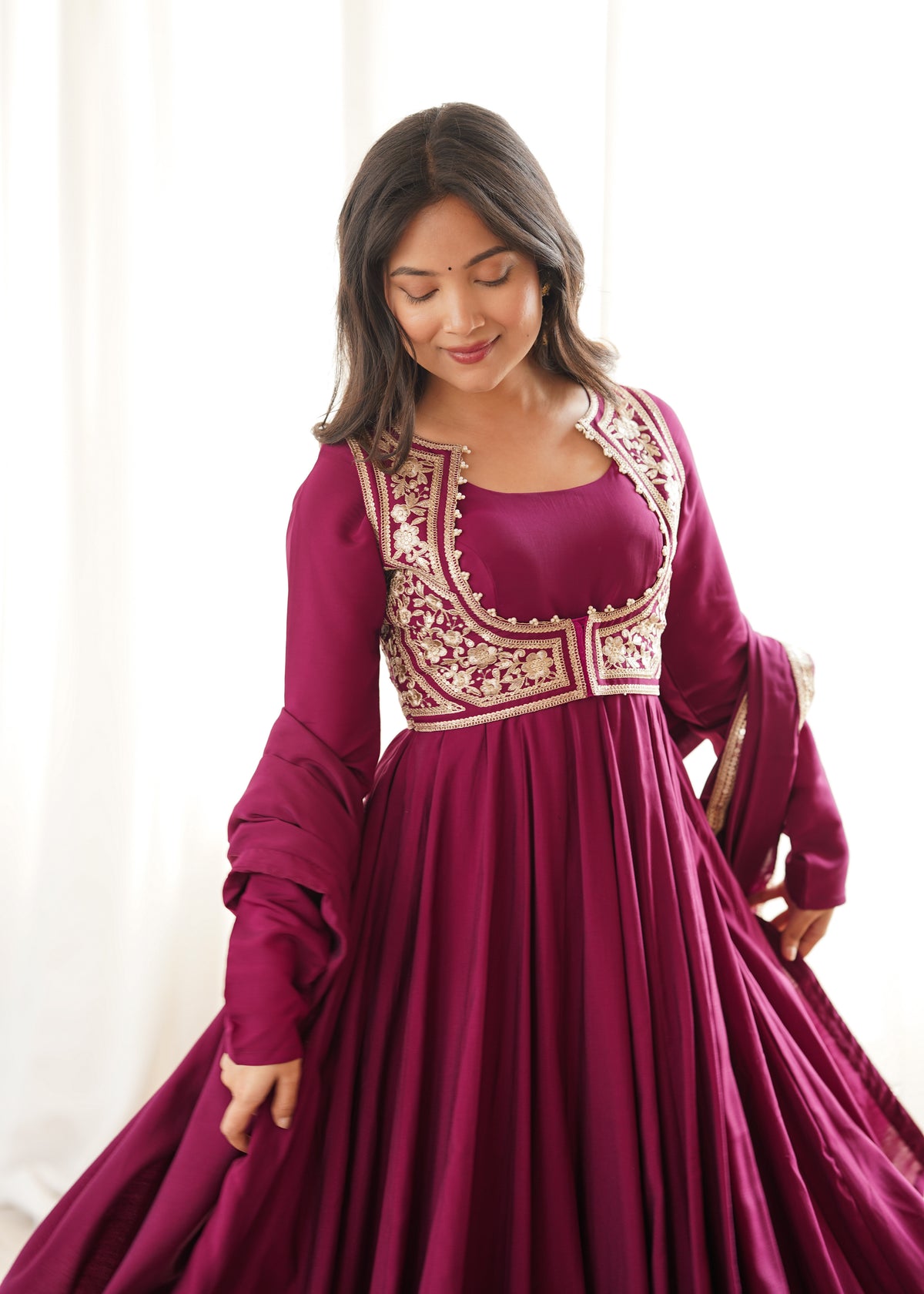 Rani pink Roman silk Anarkali gown featuring a flared silhouette and an intricately embroidered short jacket