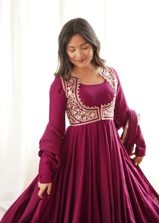 Rani pink Roman silk Anarkali gown featuring a flared silhouette and an intricately embroidered short jacket