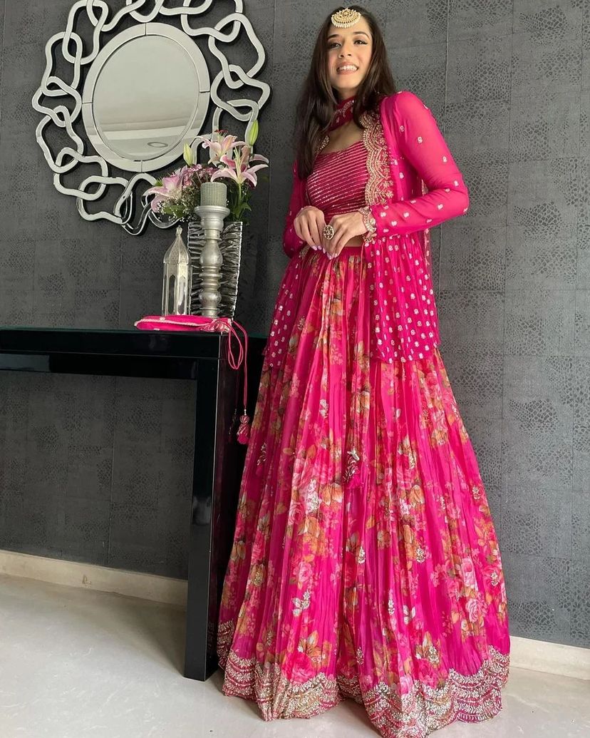 Vibrant pink floral-printed georgette lehenga choli paired with a matching sheer embroidered jacket