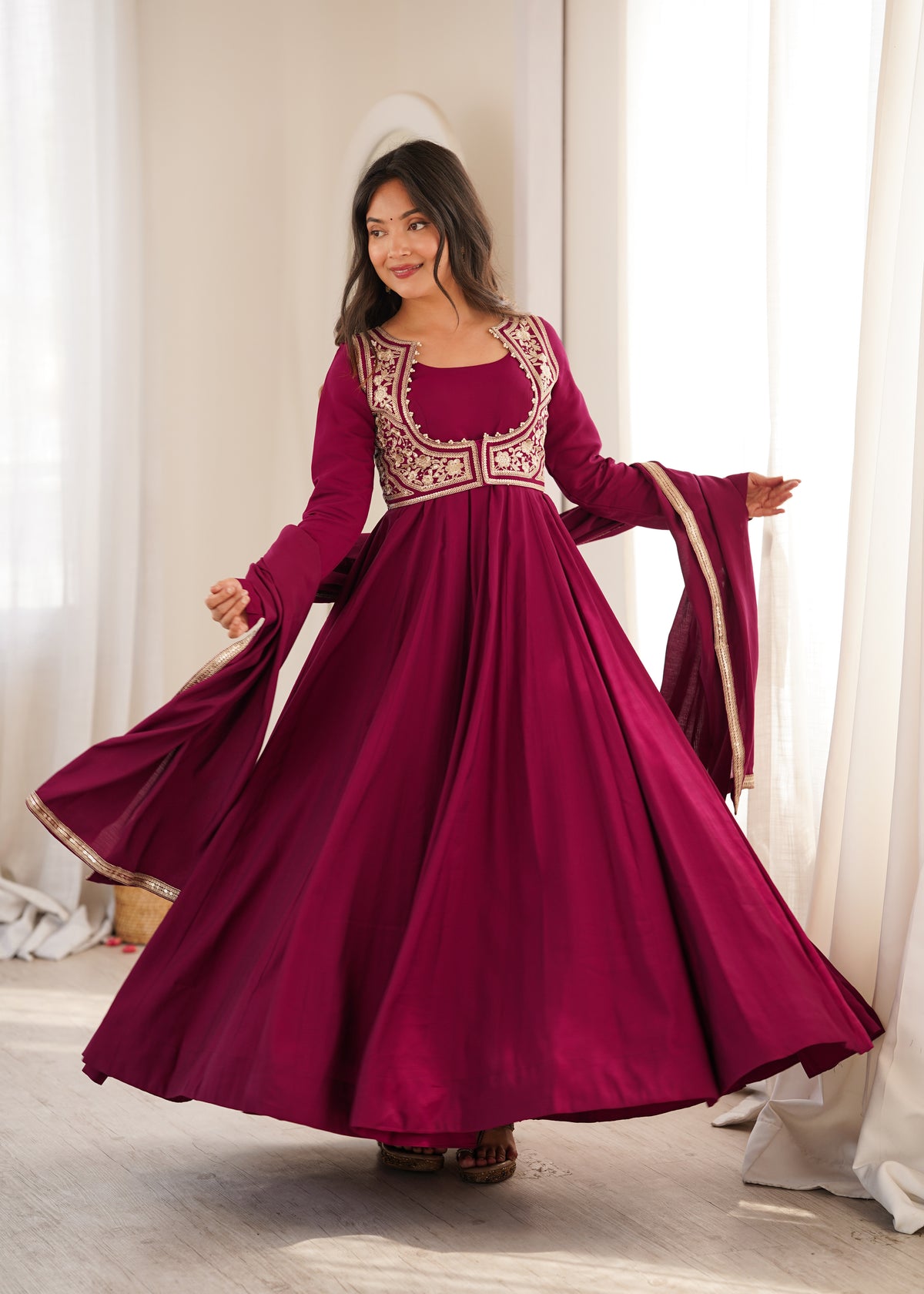 Rani pink Roman silk Anarkali gown featuring a flared silhouette and an intricately embroidered short jacket