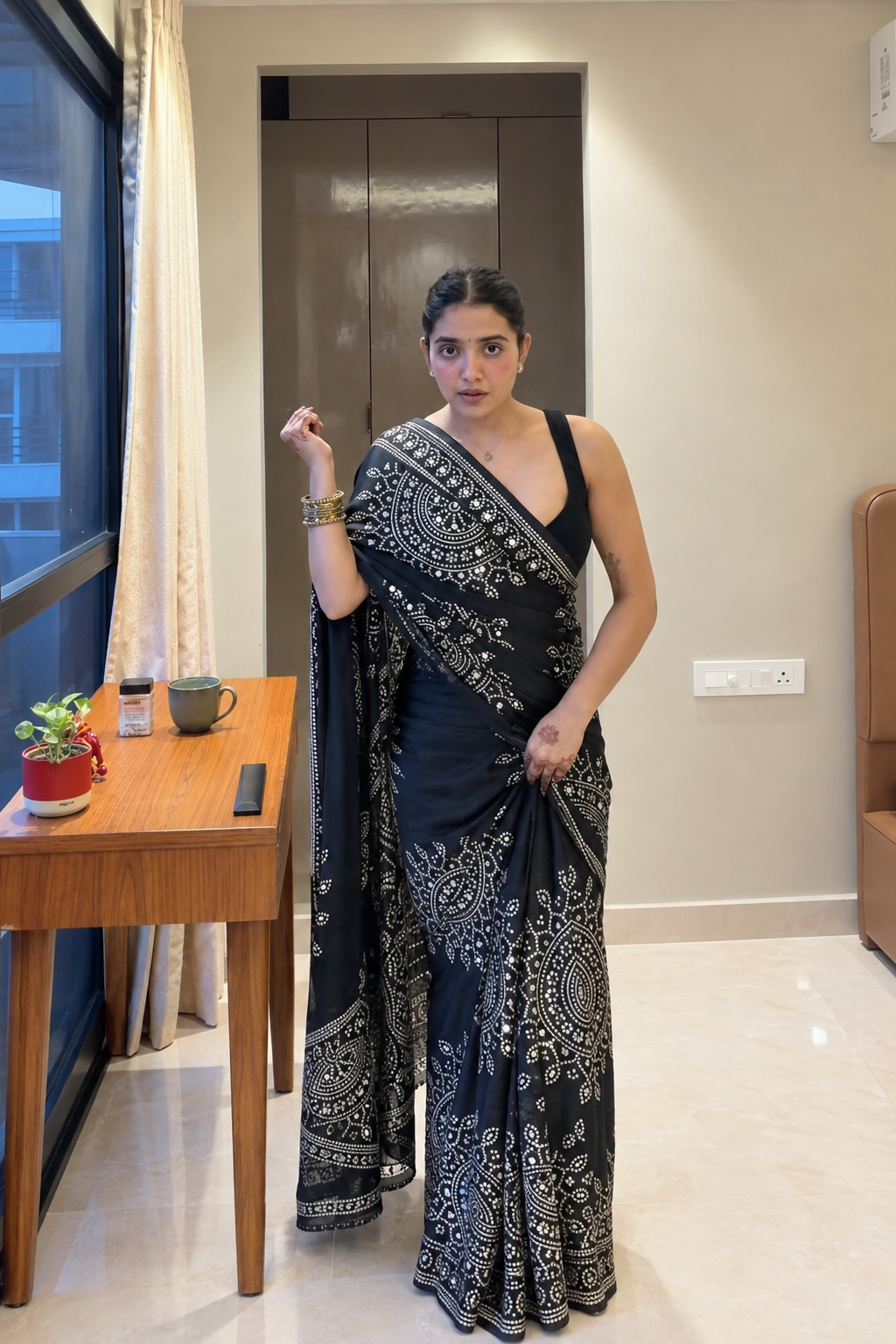 Black saree embellished with traditional Bandhani and circular motif prints and Real mirror Work
