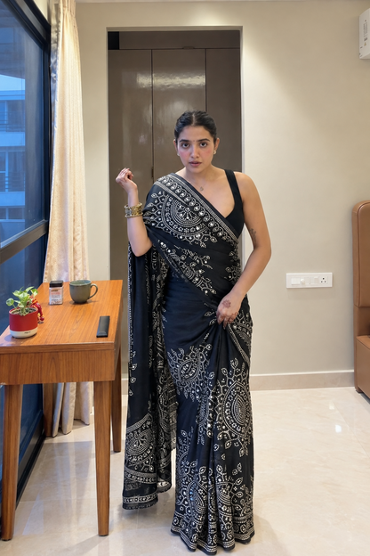 Black saree embellished with traditional Bandhani and circular motif prints and Real mirror Work